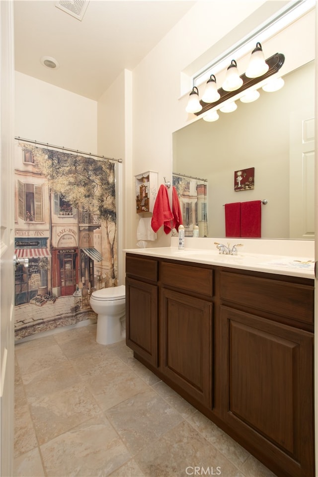 bathroom featuring vanity, toilet, and a shower with curtain