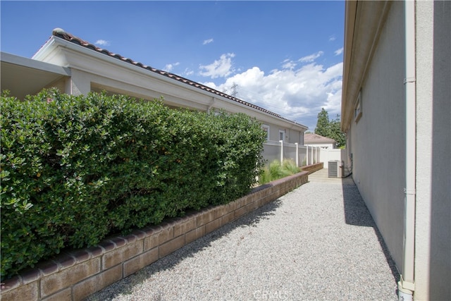 view of side of home with central AC unit