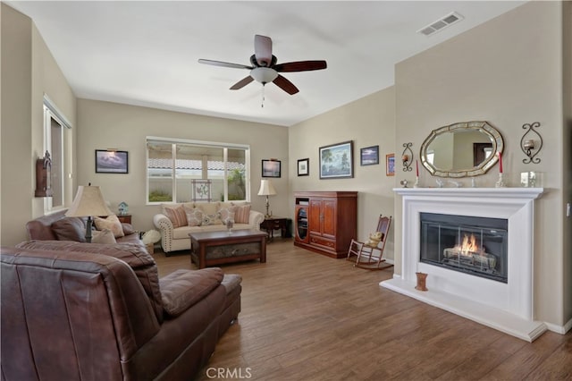 living room with ceiling fan and hardwood / wood-style floors