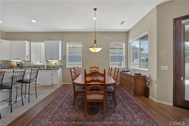 dining space with light hardwood / wood-style flooring