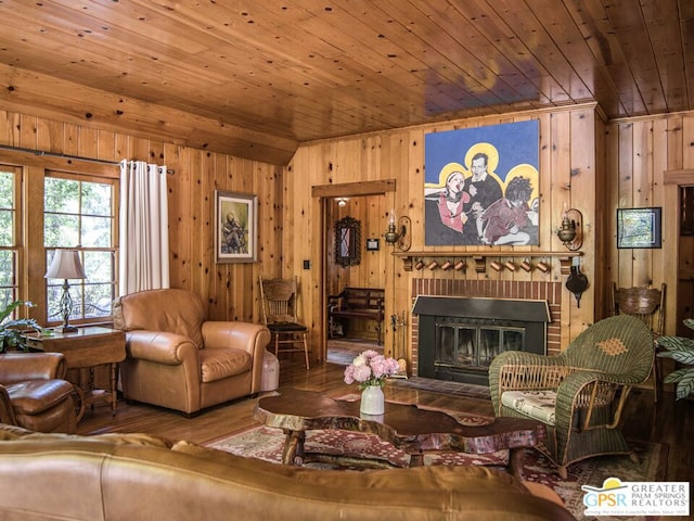 living room with wood walls, wooden ceiling, a fireplace, and hardwood / wood-style floors