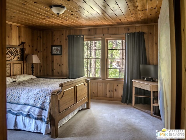 bedroom featuring wooden walls, wooden ceiling, and carpet