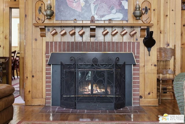 room details featuring wood-type flooring and a brick fireplace