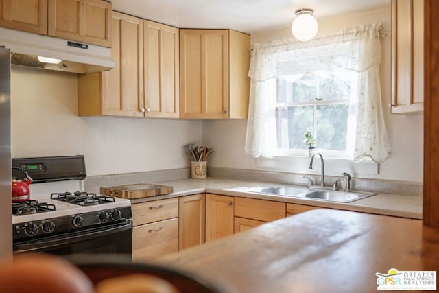 kitchen with sink, light brown cabinetry, and black range with gas cooktop