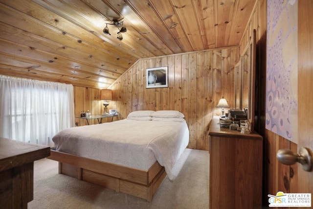 carpeted bedroom with lofted ceiling, wood ceiling, and wood walls