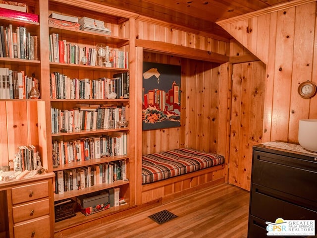 sitting room featuring wood ceiling, hardwood / wood-style flooring, and wood walls