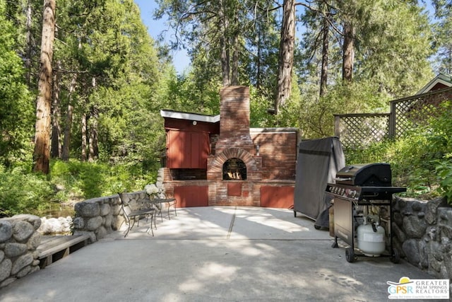 view of patio featuring an outdoor fireplace and grilling area