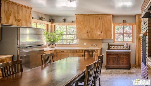 kitchen featuring a wealth of natural light and stainless steel fridge