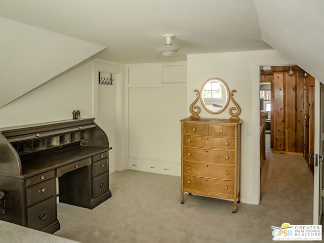 carpeted office featuring lofted ceiling