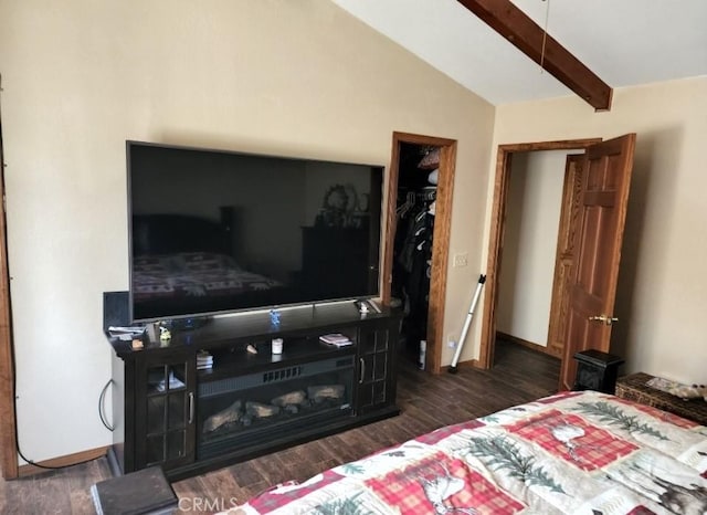 bedroom featuring vaulted ceiling with beams, dark hardwood / wood-style floors, and a closet