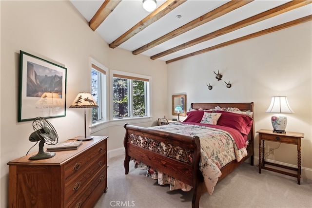 bedroom with beam ceiling and light colored carpet