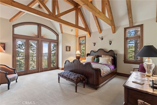 bedroom featuring high vaulted ceiling, multiple windows, and light colored carpet