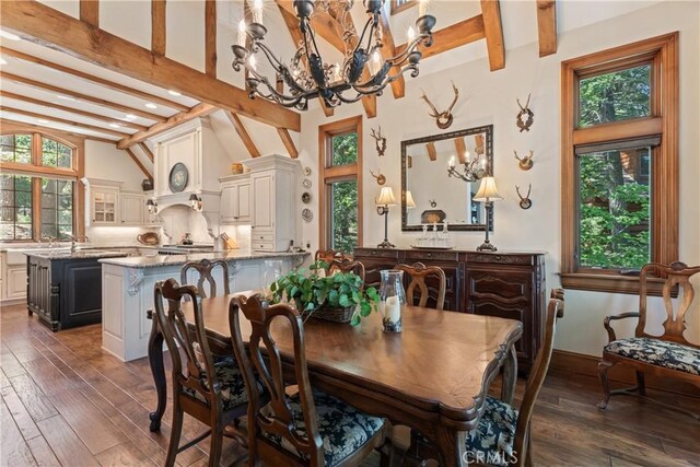 dining area featuring a chandelier, beamed ceiling, dark wood-type flooring, and a healthy amount of sunlight