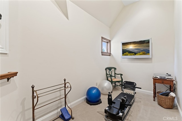 workout area featuring light colored carpet and vaulted ceiling