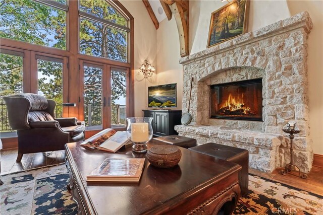 living room featuring a wealth of natural light, hardwood / wood-style floors, and a high ceiling