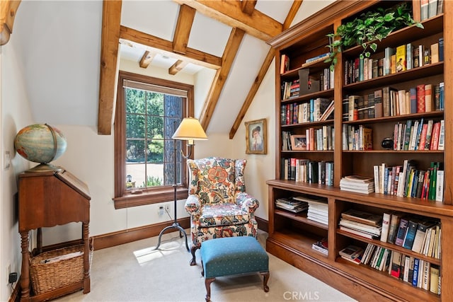 sitting room with lofted ceiling with beams and carpet