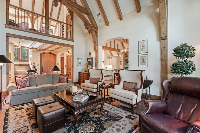 28964 Quail Run Ct, Lake Arrowhead, CA 92352 - living room with arched walkways, high vaulted ceiling, wood finished floors, beamed ceiling, and baseboards