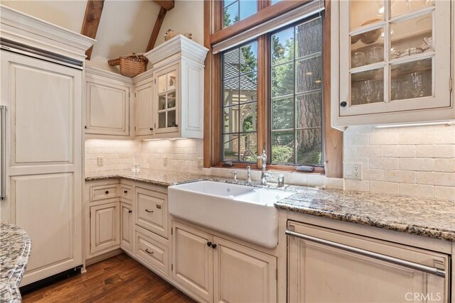 kitchen with sink, light stone countertops, and plenty of natural light