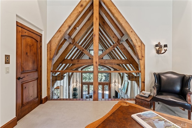 bedroom featuring beamed ceiling and high vaulted ceiling