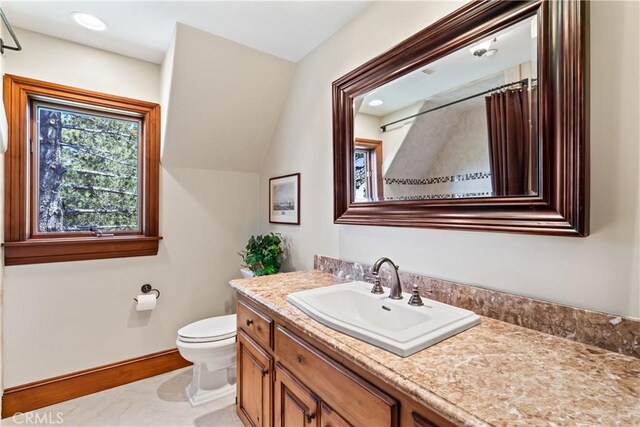 bathroom featuring vanity and toilet