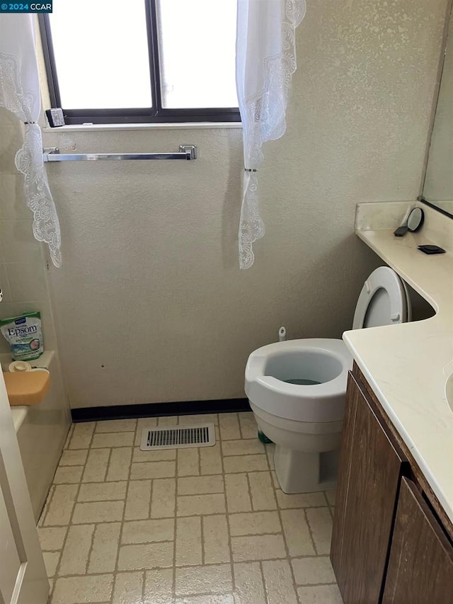 bathroom featuring vanity and toilet