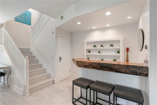 bar with light hardwood / wood-style floors