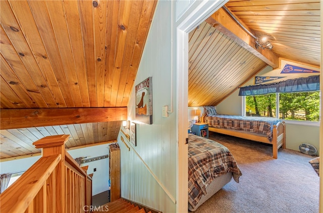 carpeted bedroom with lofted ceiling with beams and wooden ceiling