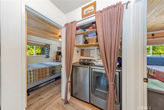 washroom featuring independent washer and dryer, ornamental molding, wooden ceiling, and light hardwood / wood-style floors