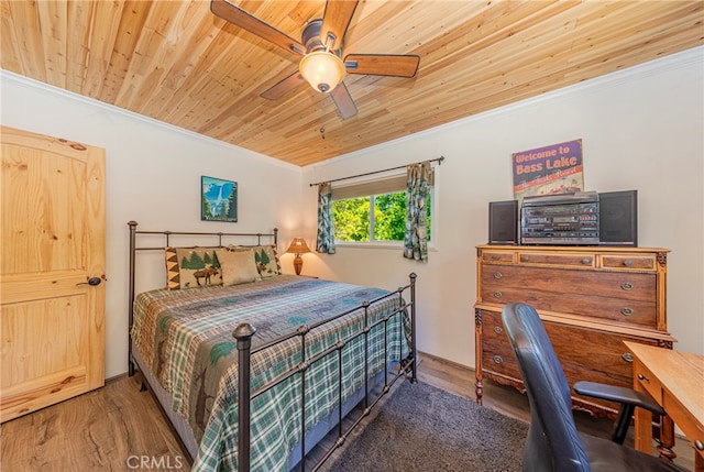 bedroom featuring crown molding, wood ceiling, dark hardwood / wood-style floors, and ceiling fan