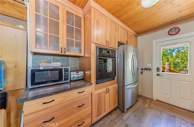 kitchen featuring appliances with stainless steel finishes, light brown cabinetry, wood ceiling, dark hardwood / wood-style flooring, and dark stone countertops