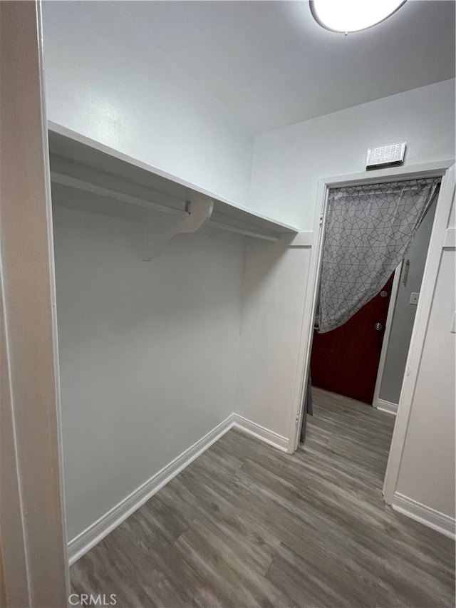 spacious closet featuring hardwood / wood-style floors