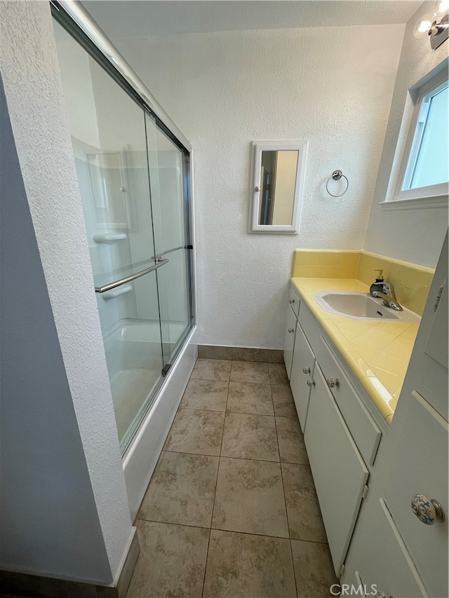 bathroom with vanity, tile patterned floors, and walk in shower