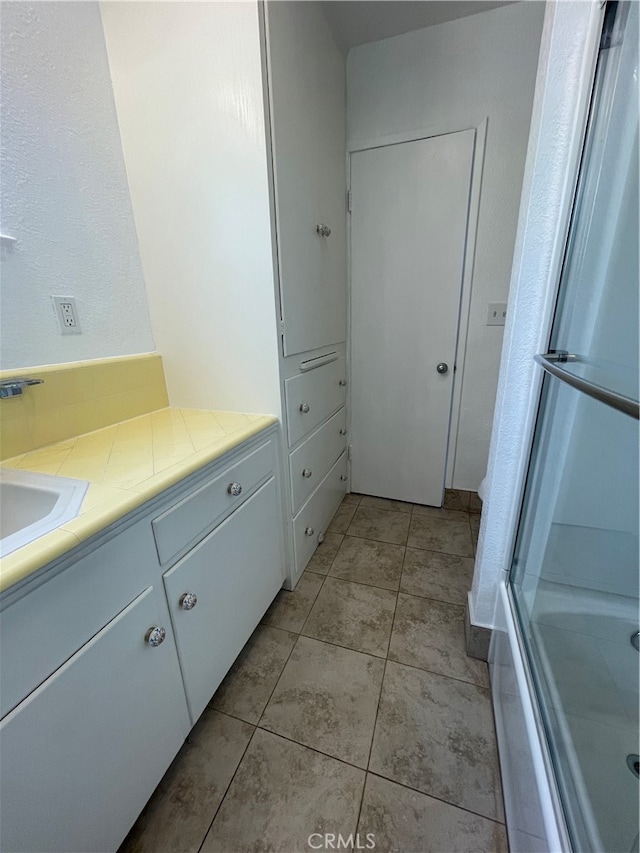 bathroom with tile patterned floors and vanity