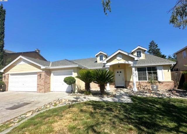 view of front of home featuring a front lawn and a garage