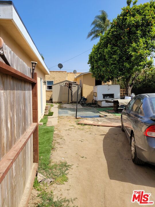 view of yard with a shed and a patio