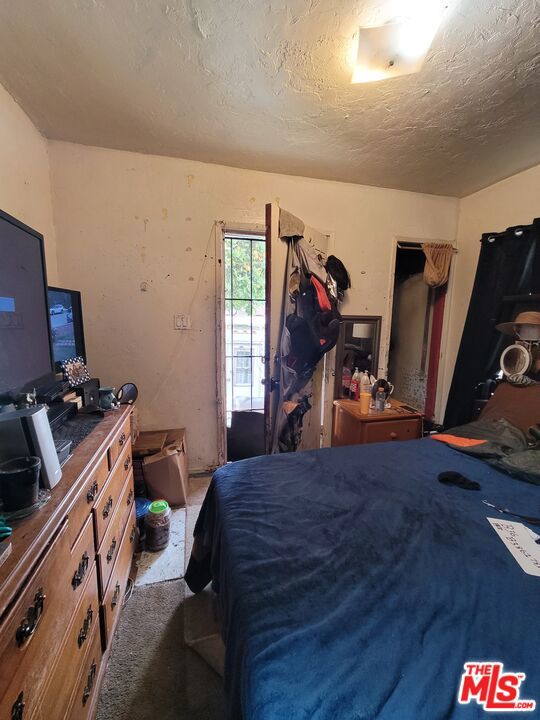 bedroom with carpet and a textured ceiling