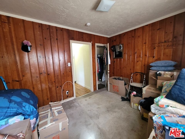 miscellaneous room with ornamental molding and wood walls