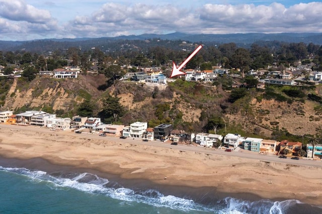 drone / aerial view with a beach view and a water view