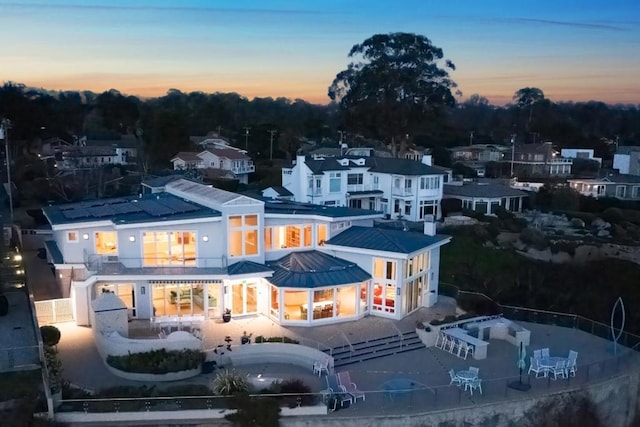 view of back house at dusk