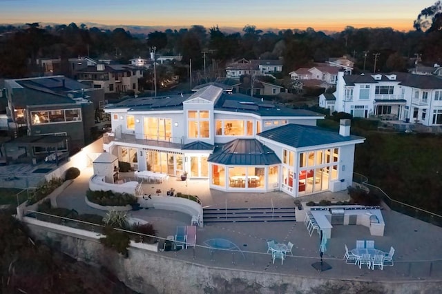 view of back house at dusk