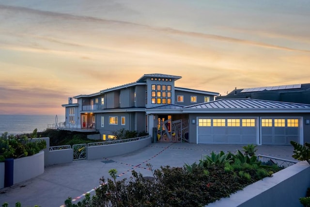 view of front facade with a garage and a water view