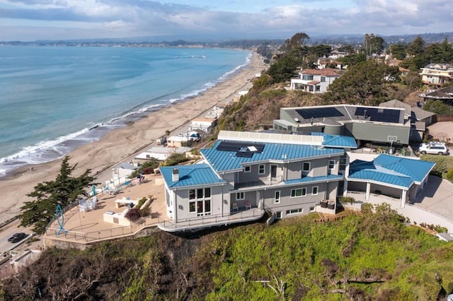 bird's eye view with a water view and a beach view