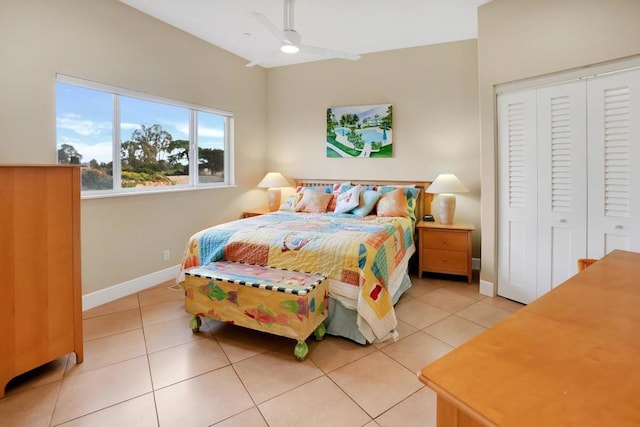 tiled bedroom with a closet and ceiling fan