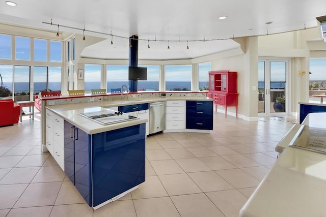 kitchen featuring white cabinetry, a water view, a center island, and dishwasher