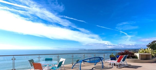 view of patio with a balcony and a water view