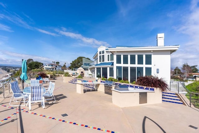 view of pool featuring a patio, an outdoor kitchen, and area for grilling