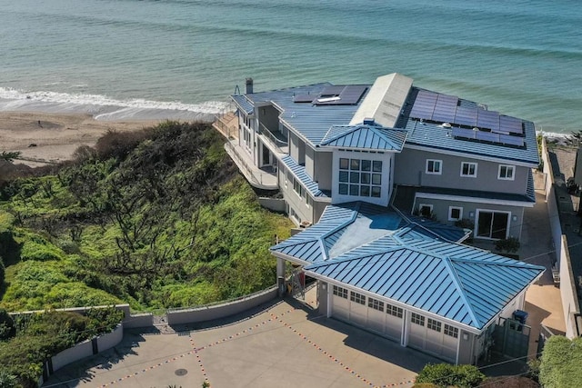 aerial view with a water view and a beach view