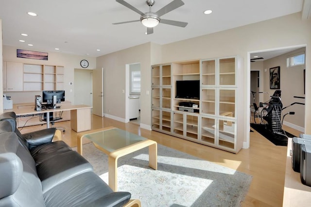 living room with light wood-type flooring and ceiling fan