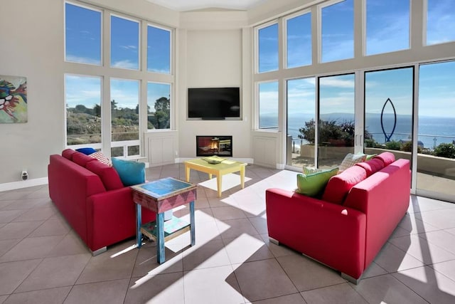 tiled living room with a towering ceiling