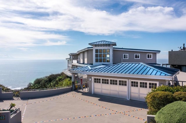 view of front of home with a water view